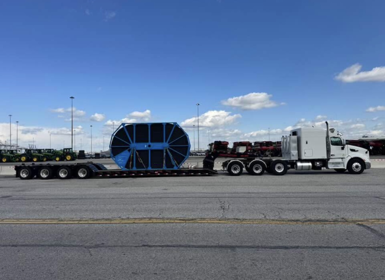 Peterbilt with lowboy hauling oversized industrial reel