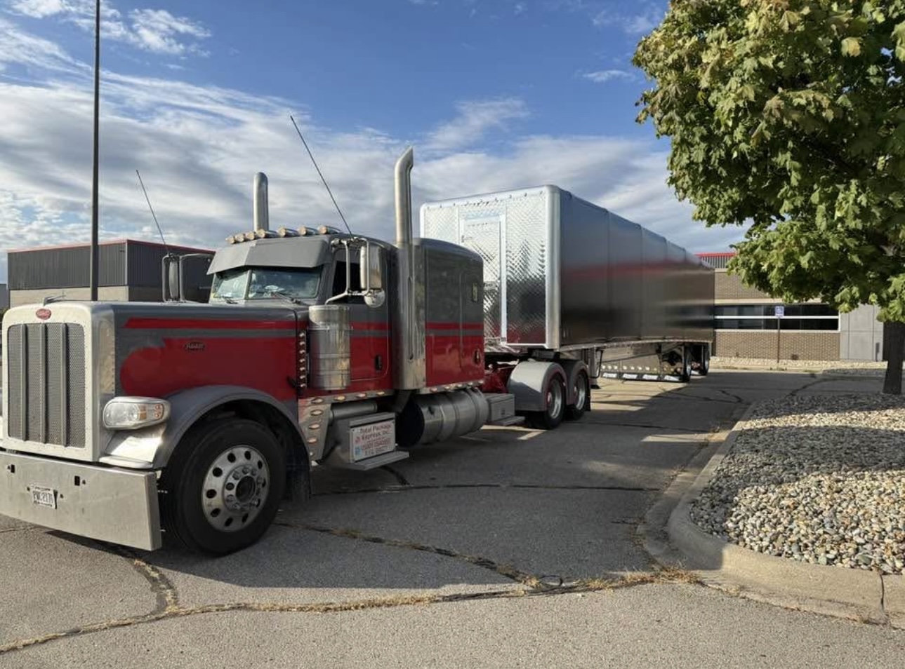 Red and silver Peterbilt with dry van trailer