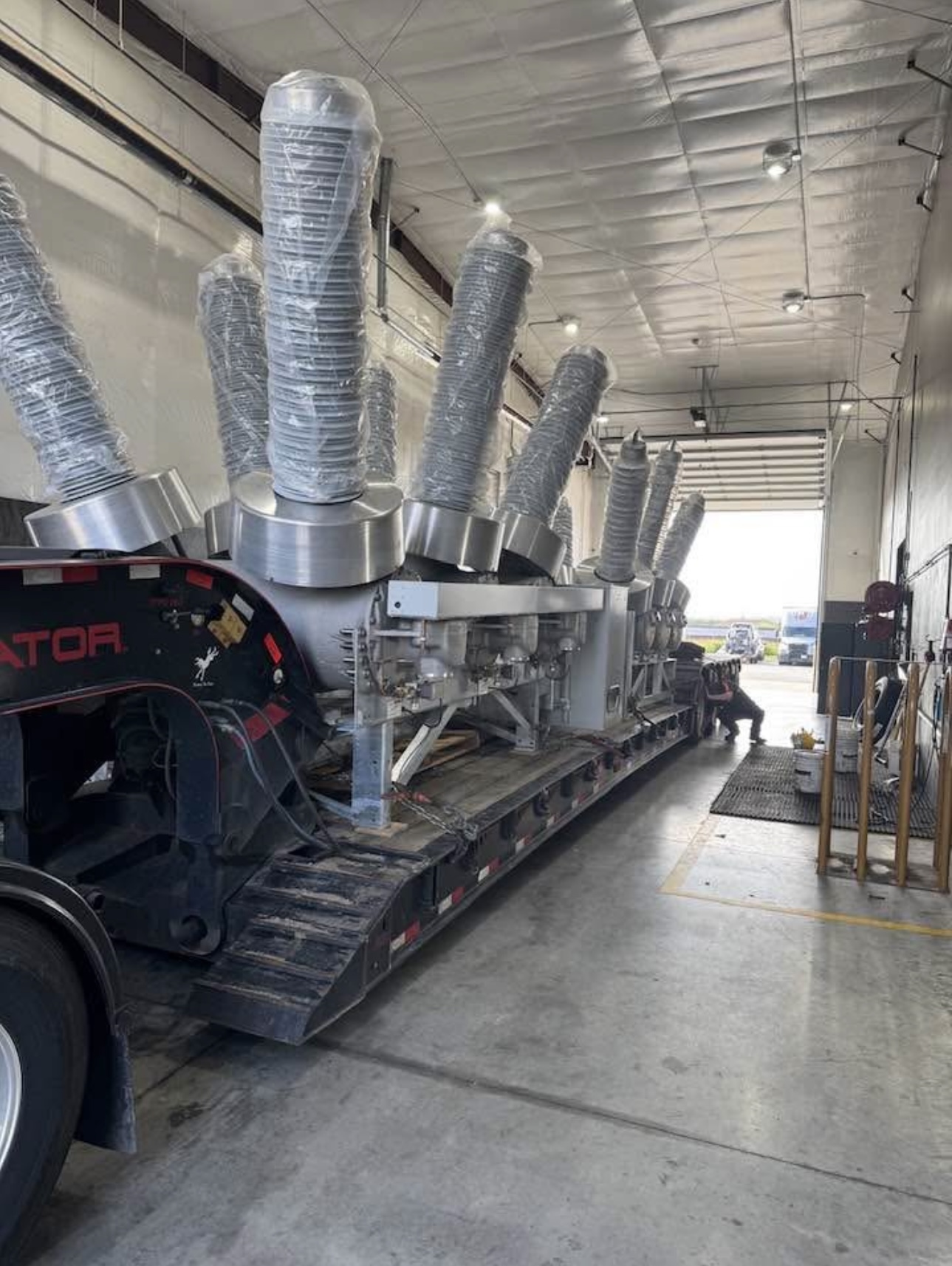 Lowboy trailer loaded with industrial transformer components
